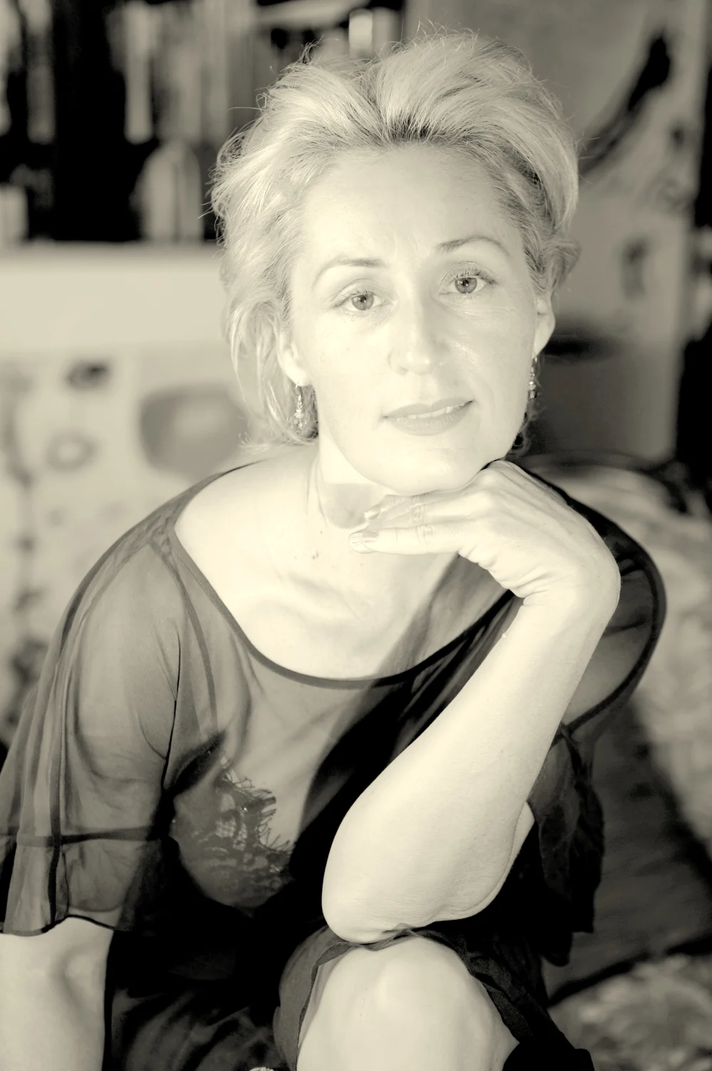 Deborah Desilets, resting her chin on her hand and looking toward the camera.
