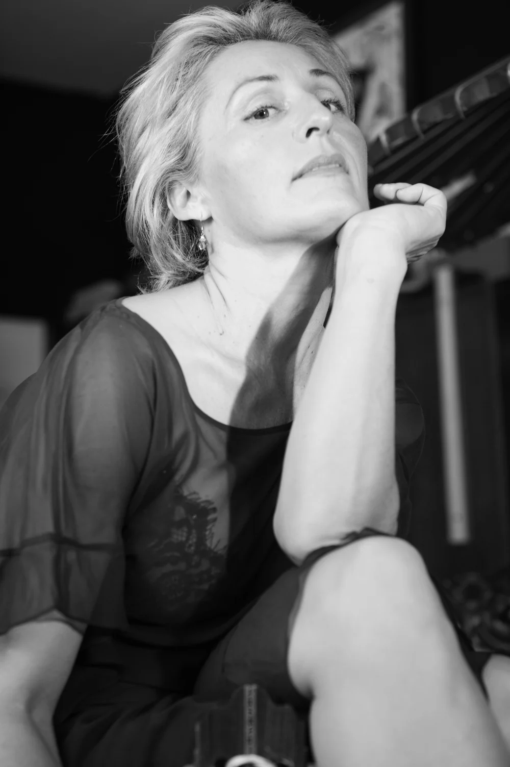 Deborah Desilets in a contemplative seated portrait.